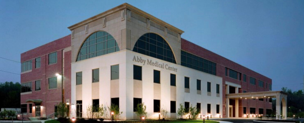 An exterior photo at night of Abby Medical Center