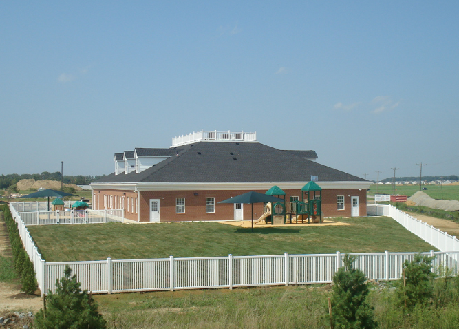 A photo of the backyard, play area of The Goddard School