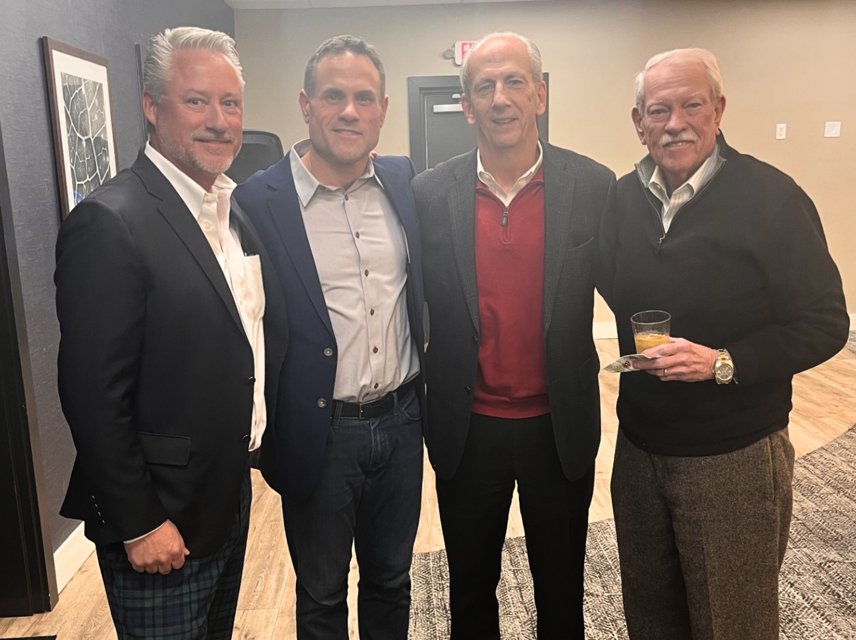 Neil, Clay, Carmen, and Bob pictured at a holiday party