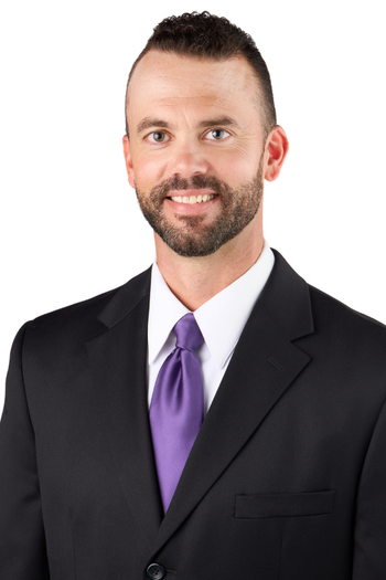 A professional headshot portrait of Phil Huber.